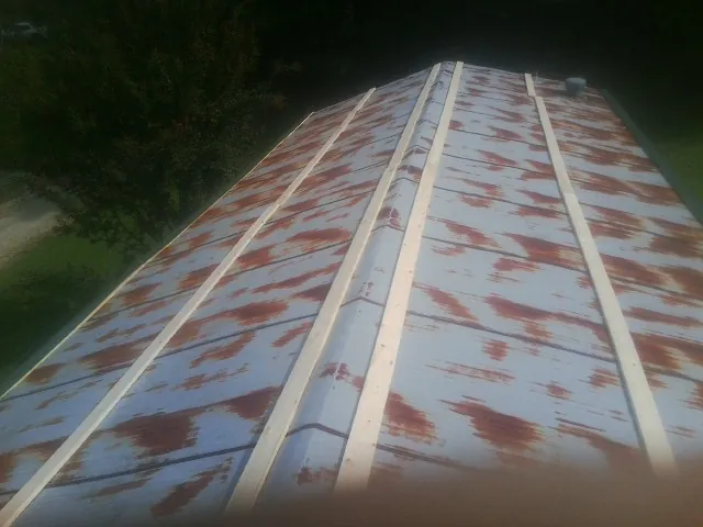 Rusted metal roof panels with new wood purlins before replacement — Storm Damage Roof Repair in Port Murray by Roofing Brothers