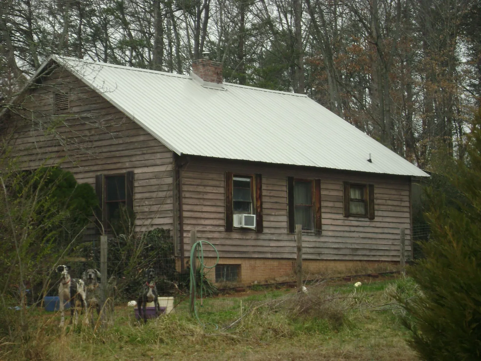 White metal roof on an old wood sided farmhouse, from a Metal Roof Installation job in Port Murray