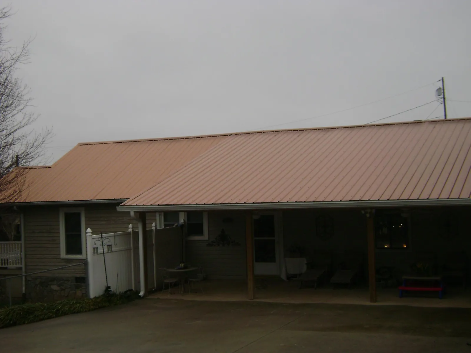 Copper toned metal roof over a wide covered patio in Port Murray
